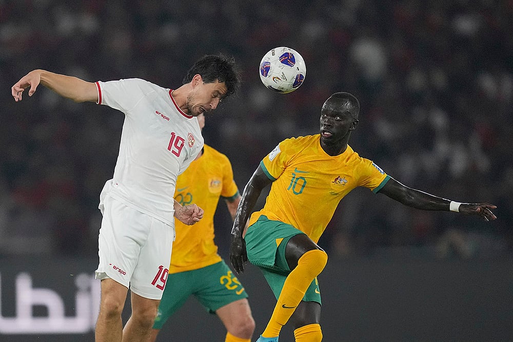 | Photo: AP/Achmad Ibrahim : 2026 FIFA World Cup Qualifying, Indonesia Australia: Indonesia's Thom Jan Haye, left, battles for the ball against Australia's Awer Mabil 